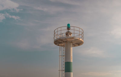 Low angle view of small light tower against sky