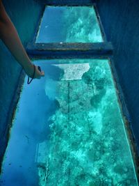 High angle view of hand on sea by swimming pool