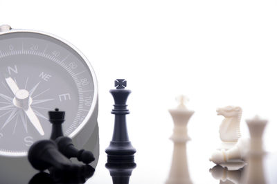 Close-up of chess pieces against white background