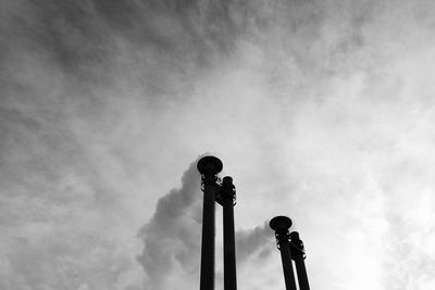 Low angle view of smoke stack against cloudy sky