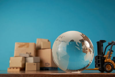 Low angle view of globe against clear blue sky