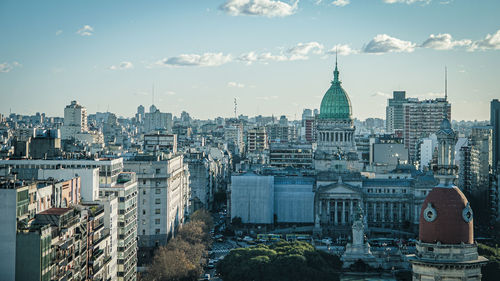 Buildings in city against sky