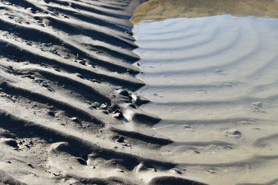 High angle view of tire tracks on beach