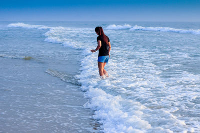 Woman standing on sea shore