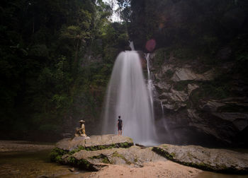 Scenic view of waterfall against trees