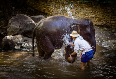 Man splashing water in river