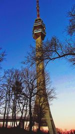 Low angle view of tower against blue sky