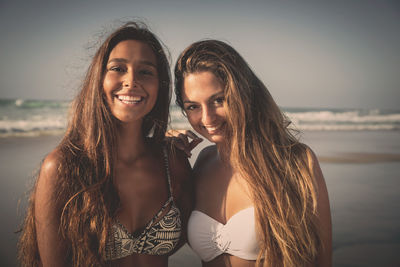 Portrait of smiling woman against sea against sky