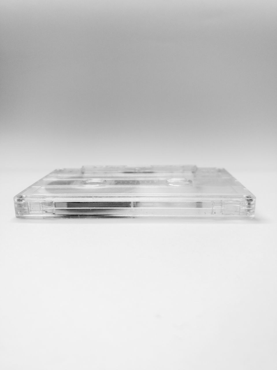 CLOSE-UP OF STACK OF GLASS TABLE