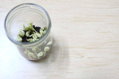 High angle view of chopped coffee in glass on table