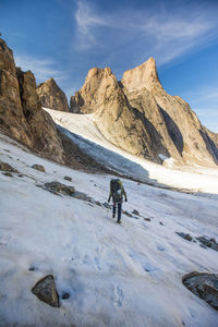 Mountaineer crosses glacier on approach to mount asgard.