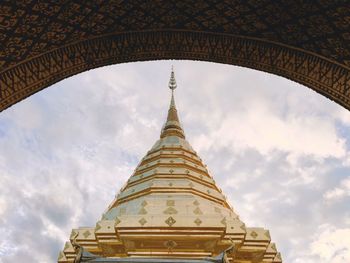 Low angle view of pagoda against cloudy sky