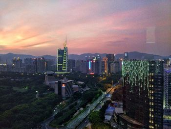 View of cityscape against cloudy sky