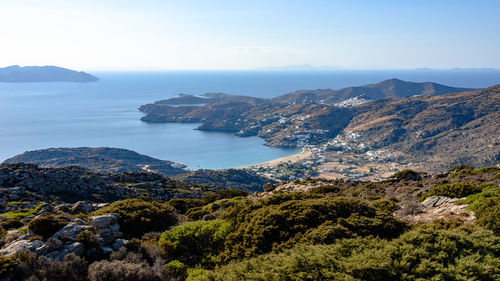 Scenic view of sea and mountains against sky