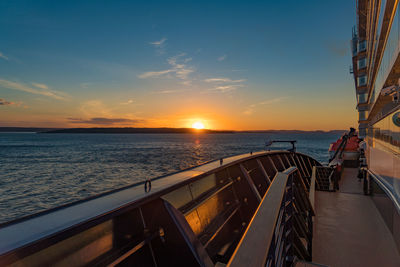 Ship in sea against sky during sunset 