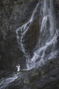 Low angle view of waterfall on rock formation