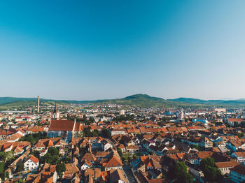 High angle view of townscape against blue sky