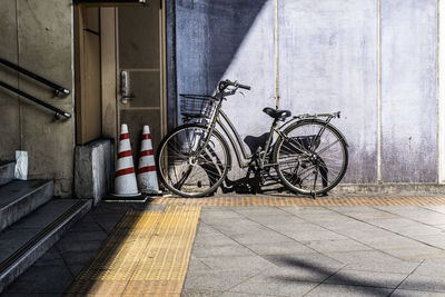 Bicycle parked against wall