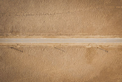 A lonely road through the californian desert from above