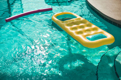 High angle view of yellow floating in swimming pool