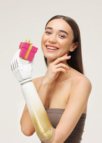 Portrait of beautiful young woman against white background