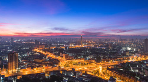 High angle view of illuminated buildings against sky at night