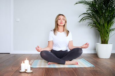 Happy young woman sitting on floor