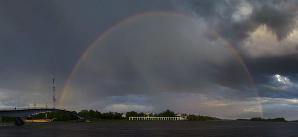 Rainbow over building against sky