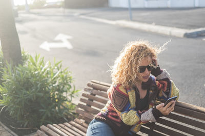 Full length of woman sitting outdoors