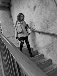 Low angle view of woman standing on staircase