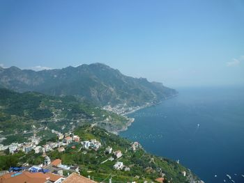 High angle view of townscape by sea against sky