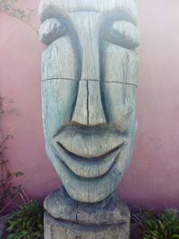 Close-up of buddha statue against wall