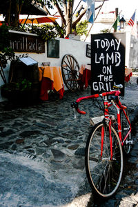 Bicycle parked on sign in city