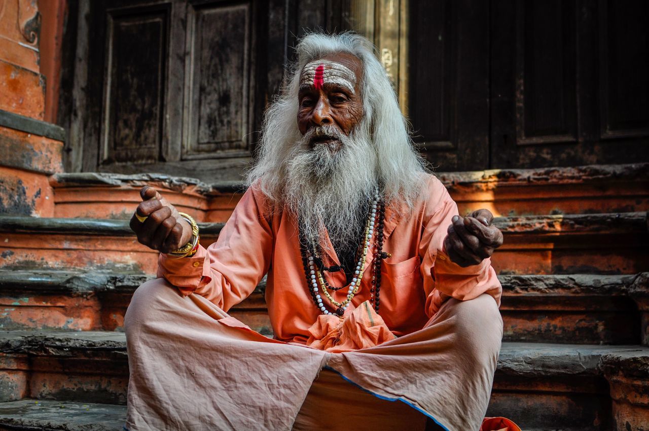 sitting, one person, architecture, senior adult, front view, men, portrait, beard, adult, religion, males, senior men, built structure, facial hair, three quarter length, belief, staircase, real people, spirituality