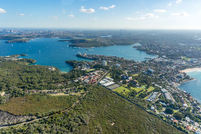 High angle view of townscape by sea against sky