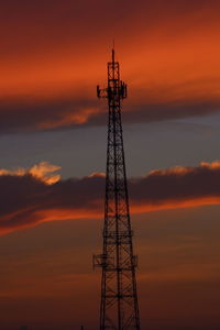 Low angle view of communications tower against sky during sunset