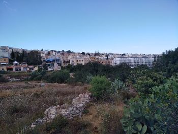Buildings against clear blue sky