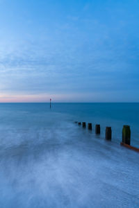 Scenic view of sea against blue sky