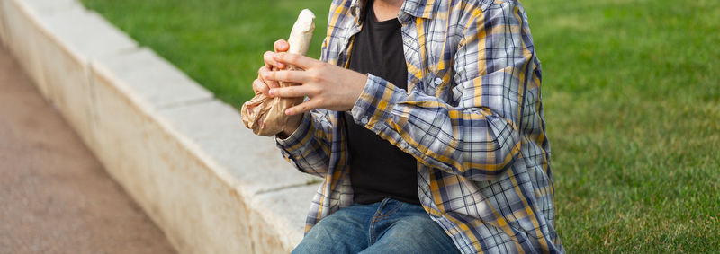 Low section of man using mobile phone