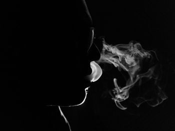 Close-up of cigarette against black background