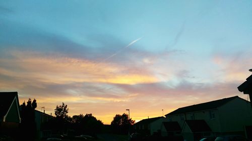 Low angle view of building against sky at sunset