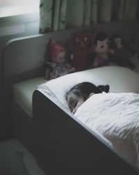 High angle view of girl sleeping on bed at home