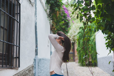 Full length of woman standing on tree trunk