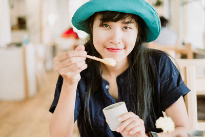 Portrait of smiling woman holding ice cream