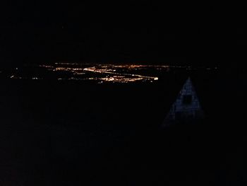 Illuminated city against sky at night