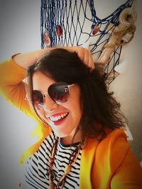 Portrait of smiling young woman wearing sunglasses
