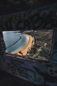 High angle view of reflection of building in sea