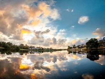 Scenic view of lake against sky at sunset