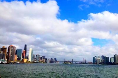 City skyline against cloudy sky