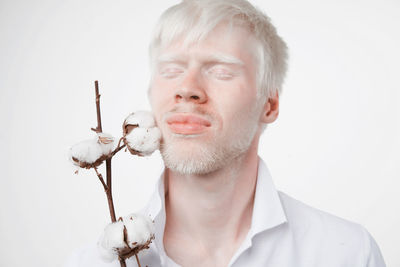 Portrait of man holding white background